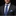 Man wearing a dark suit with a patterned purple tie and pocket square against a black background