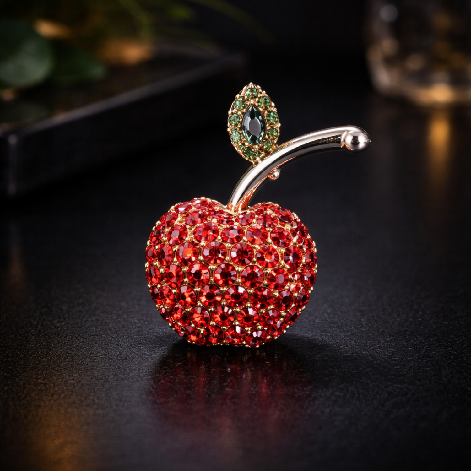 Decorative apple with gemstone top on a dark surface