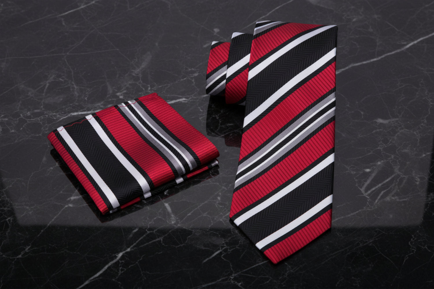 Red, black, and white striped tie and pocket square set 