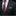 Black suit with a red paisley tie and patterned pocket square on a black background