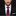 Man wearing a black suit with a red and black patterned tie on a dark background
