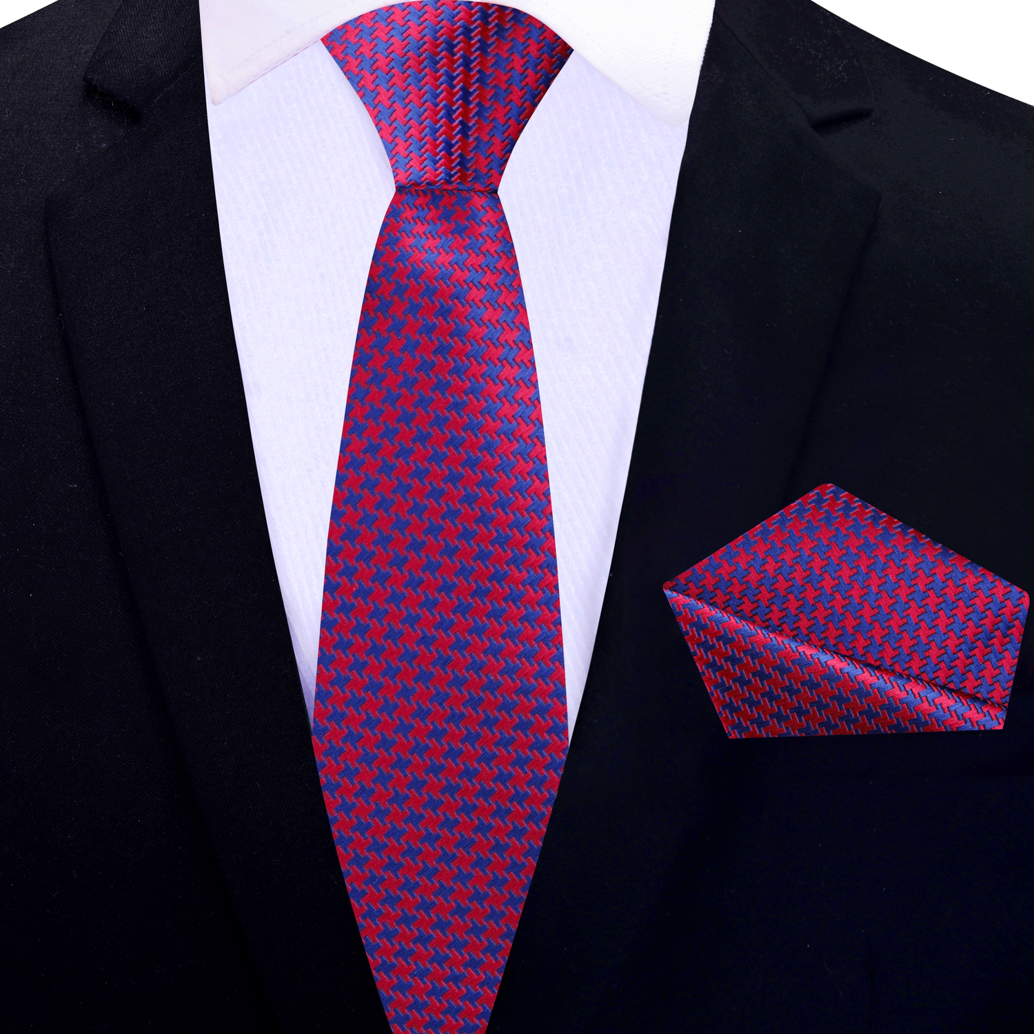 Red and blue patterned thin tie and pocket square on a black suit jacket.