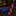 A men's necktie and matching pocket square set displayed on a dark marble surface in a luxury clothing store. The pocket square is royal blue with small white dots, and the tie features a diagonal plaid pattern in red and navy blue.