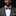 Man wearing a gray suit with a white shirt and a colorful bow tie against a black background