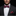 Man wearing a black suit with a white shirt and red floral bow tie and pocket square.