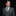 Man wearing a gray suit with a colorful tie and pocket square on a black background