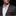 Man wearing a gray suit with a white shirt and red pocket square on a black background