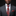 Man wearing a gray suit with a red paisley tie and pocket square against a black background
