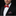 Man wearing a black suit with a red bow tie and matching pocket square on a black background