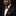 Man wearing a black suit with a red bow tie and pocket square on a black background