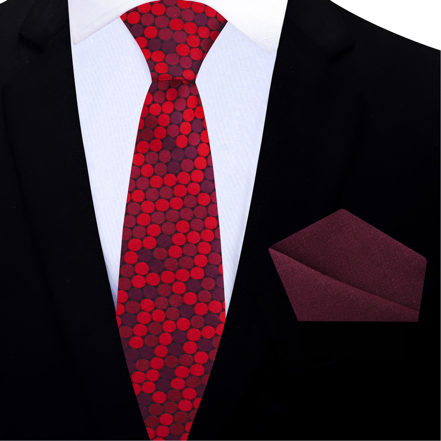 Red patterned thin tie and red pocket square on a black suit jacket.