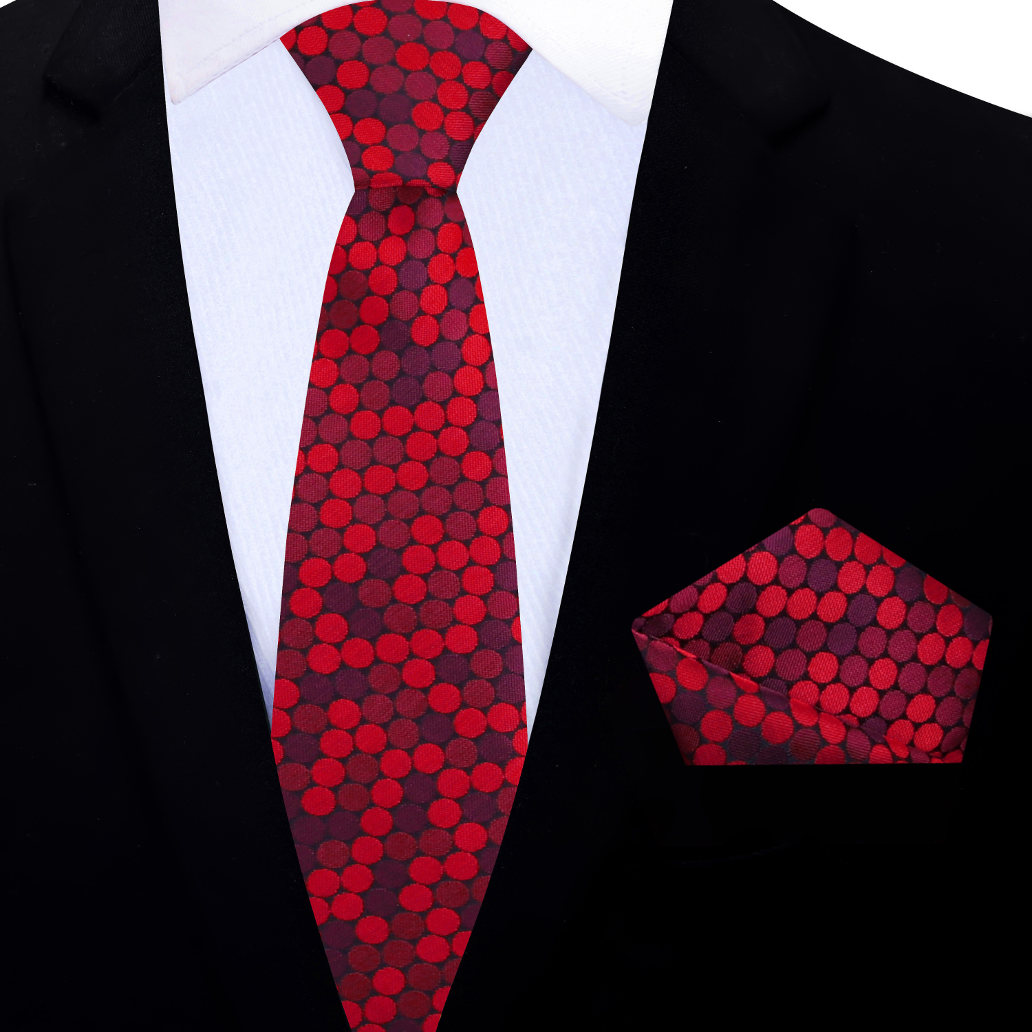 Red polka dot thin tie and matching pocket square on a black suit jacket.