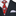 Close-up of a suit with a red and blue patterned tie and white pocket square.