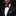 Man wearing a black suit with a red and grey patterned bow tie and pocket square on a black background
