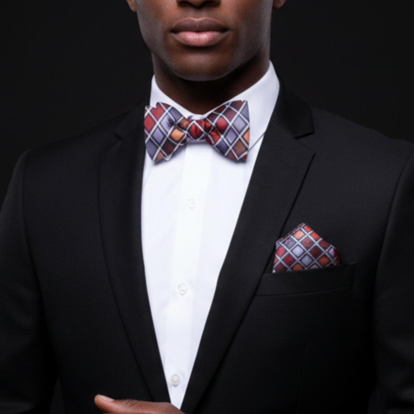 man wearing red and grey geometric bow tie an square