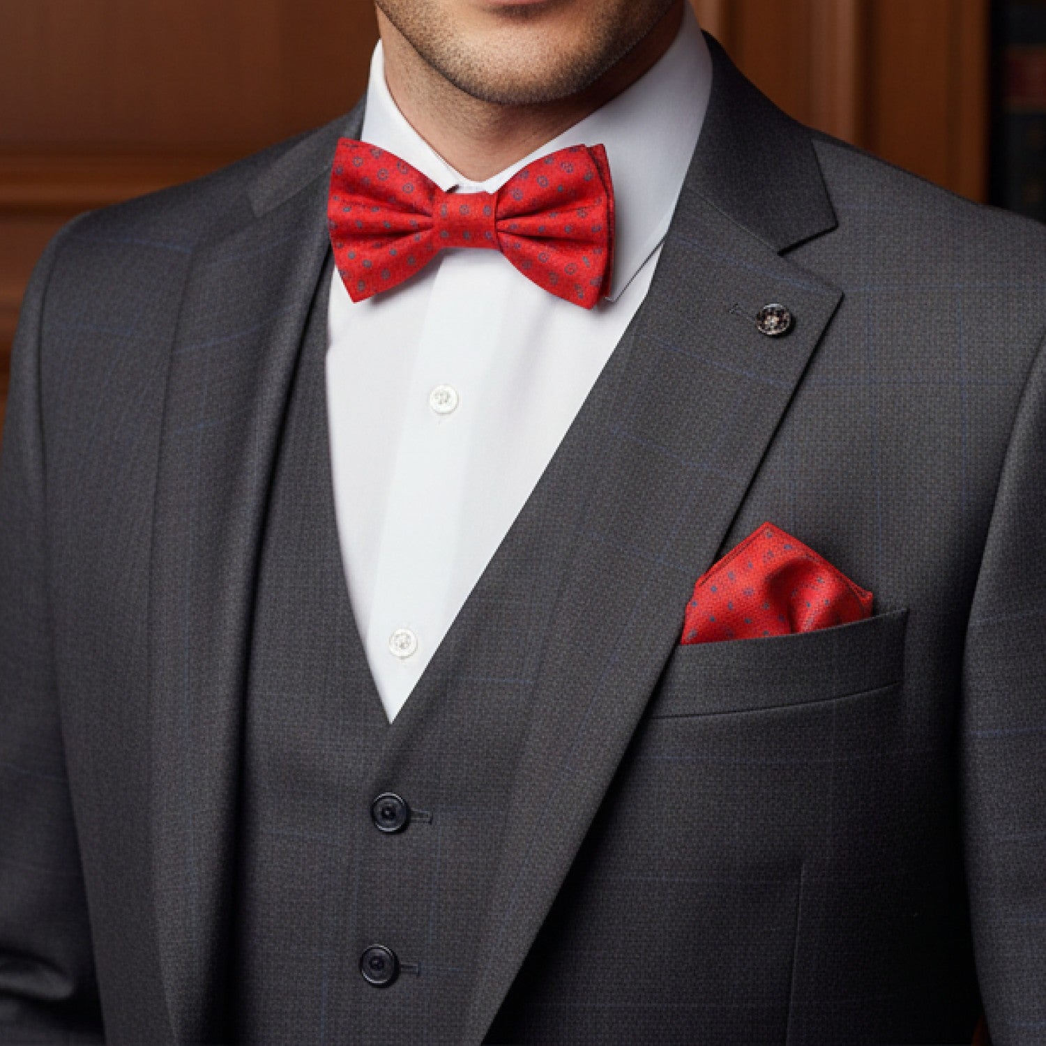 Gray suit with red bow tie and pocket square on a blurred background