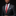 Man wearing a dark suit with a red tie and patterned pocket square on a black background