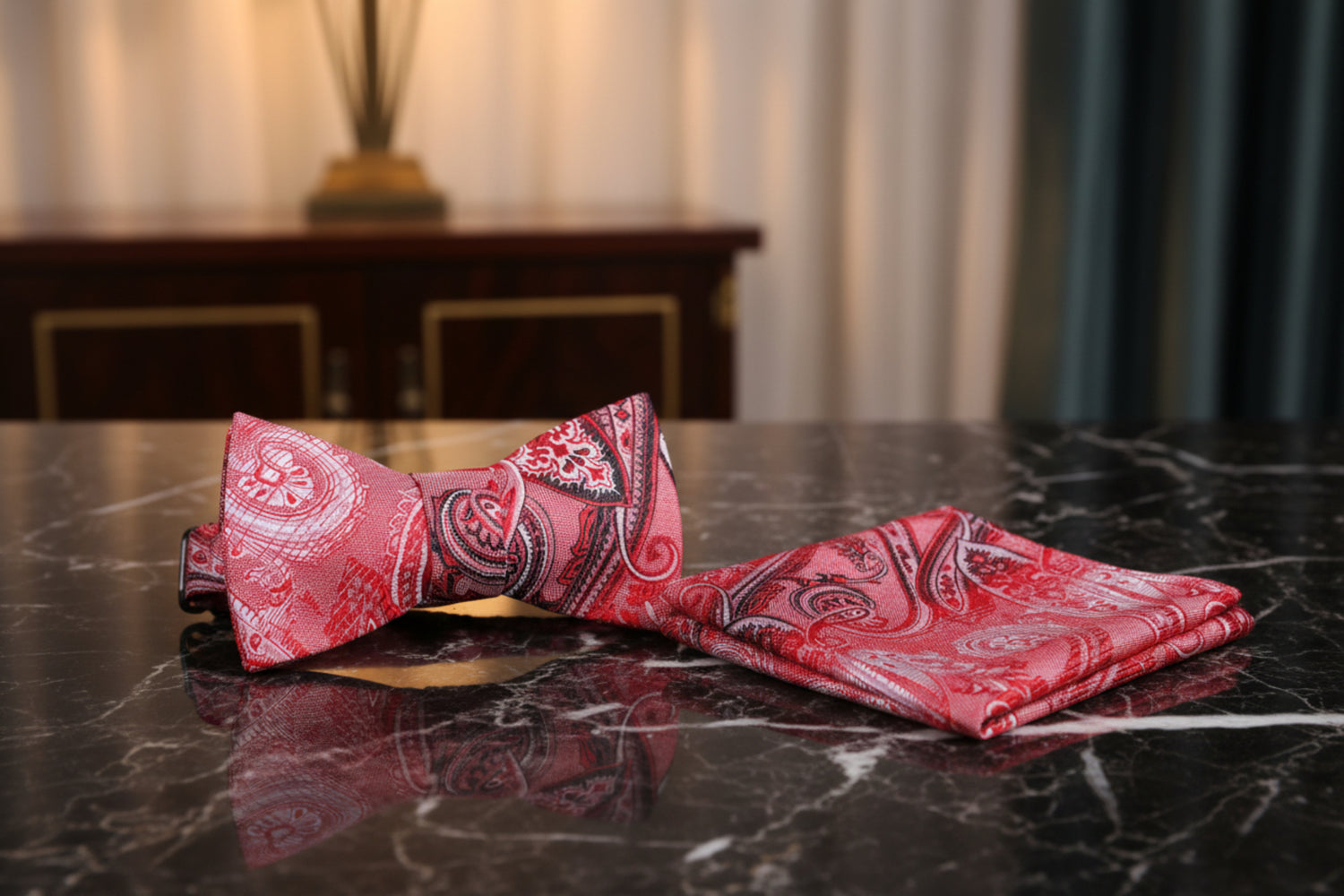 Red paisley bow tie and matching pocket square on man with suit