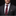 Man wearing a dark suit with a red patterned tie and pocket square against a black background