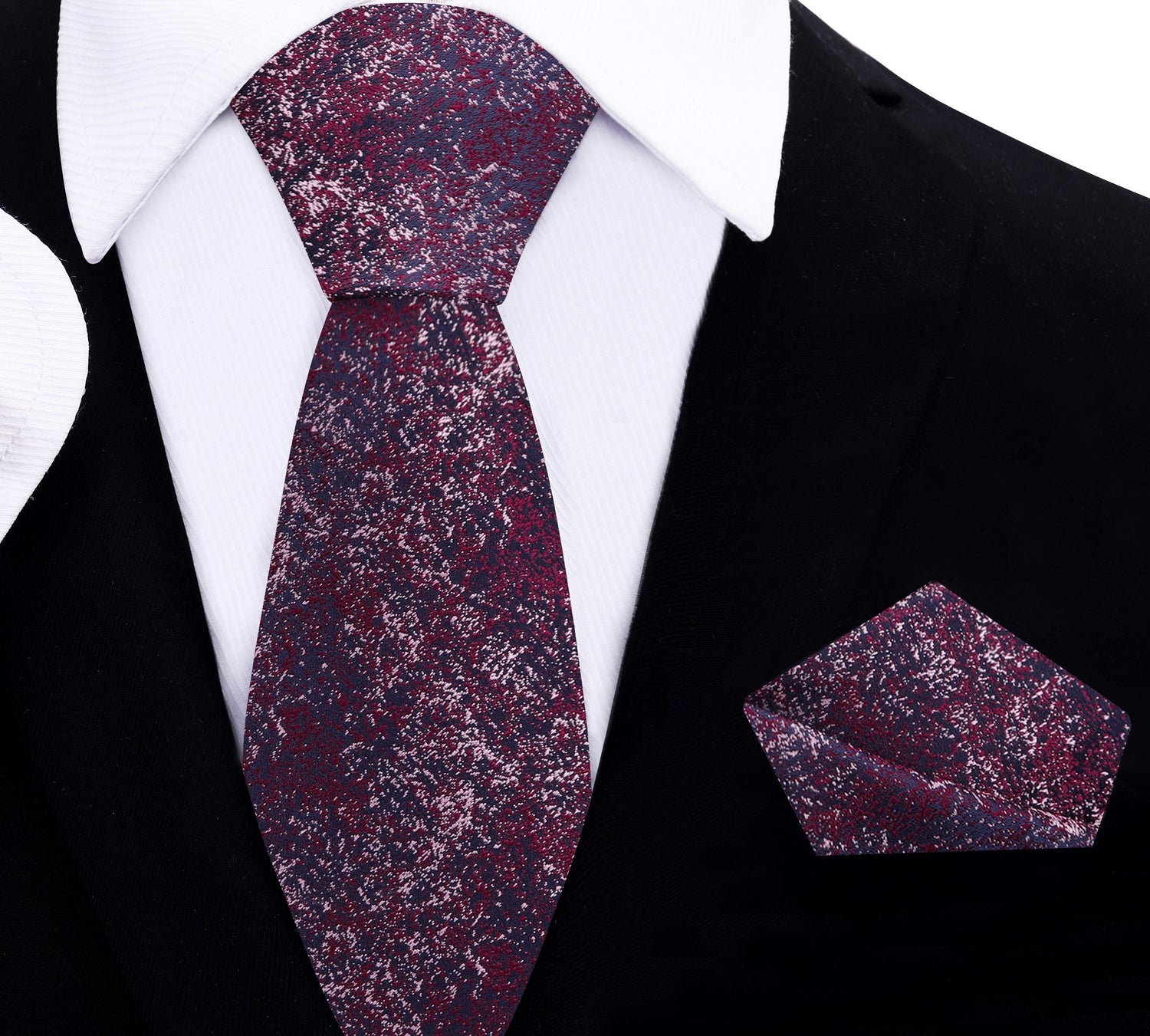Maroon patterned thin tie and matching pocket square on a black suit jacket.
