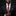 Man wearing a black suit with a red paisley tie and pocket square on a dark background