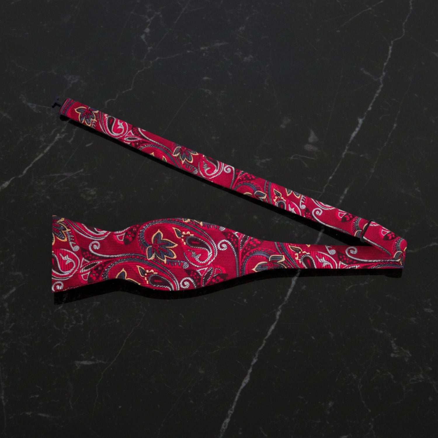 Single Self Tie Bow Tie With A Red Paisley Pattern