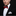 Man wearing a black suit with a red bow tie and white pocket square on a dark background