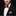 Man wearing a black suit with a red bow tie and matching pocket square on a black background