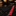 A red necktie with a white and black floral pattern lies on a black marble countertop next to a folded black pocket square, with a blurred suit boutique in the background.