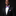 Man wearing a black suit with a red, white, and blue stripe bow tie and pocket square on a dark background