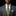Man wearing a gray suit with a Orange, Red and Yellow Abstract Tie and white shirt on a black background