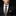 Man wearing a black suit with a patterned tie and pocket square on a black background