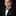 Young boy in a formal suit with a bow tie and pocket square on a black background