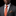 Man wearing a gray suit with a red tie and pocket square on a black background