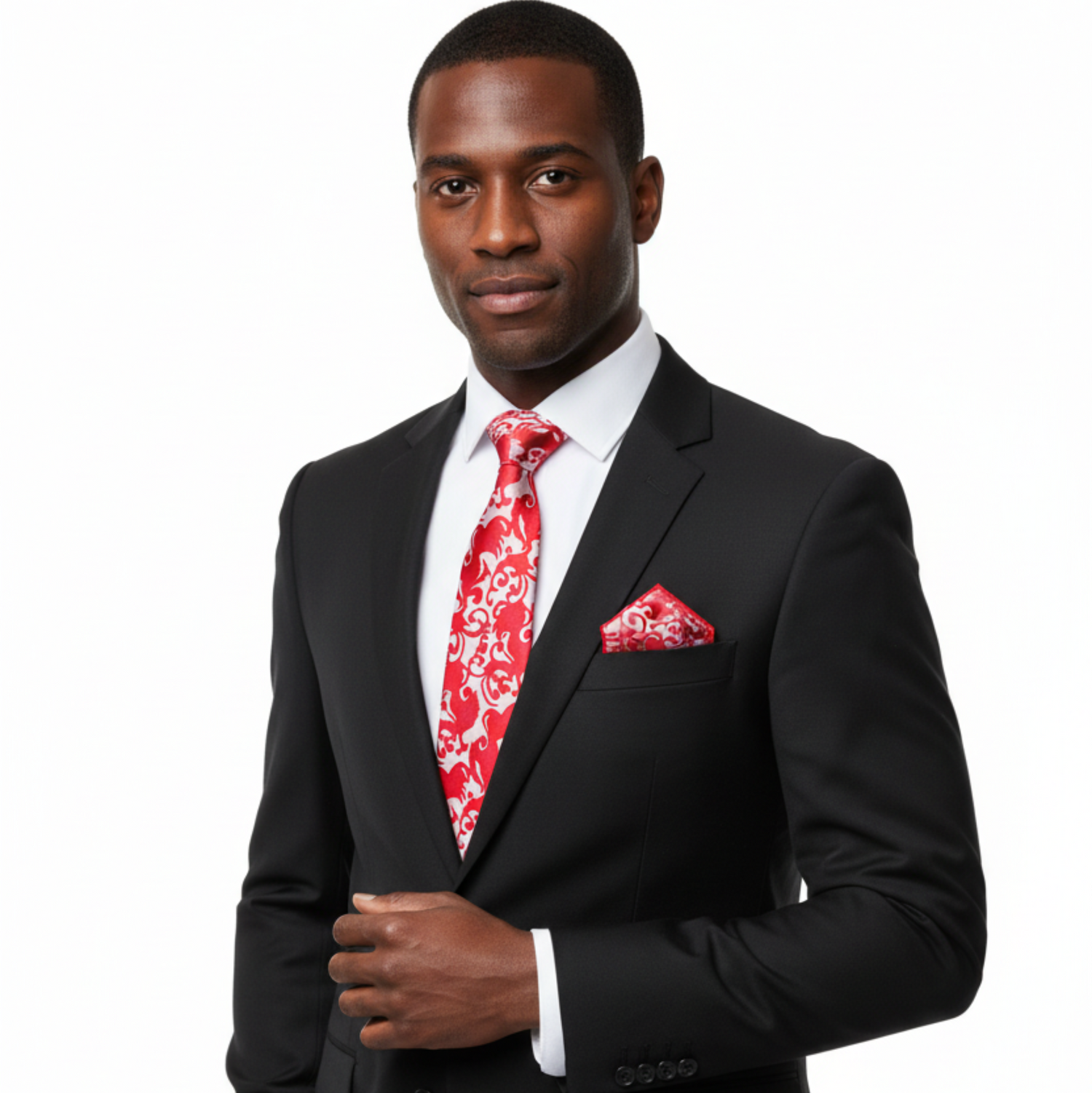 Man wearing a black suit with a red patterned tie and pocket square on a white background