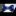 Blue floral bow tie on a white shirt against a dark background