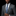 Man wearing a gray suit with a blue patterned tie and pocket square on a black background