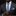 Man wearing a dark suit with a blue patterned tie and a red, white, and blue pocket square.