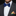 Man wearing a blue bow tie and colorful pocket square with a black suit.