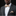 Man wearing a gray suit with a patterned bow tie and pocket square on a black background