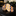 Plaid tie on a reflective surface with a blurred background