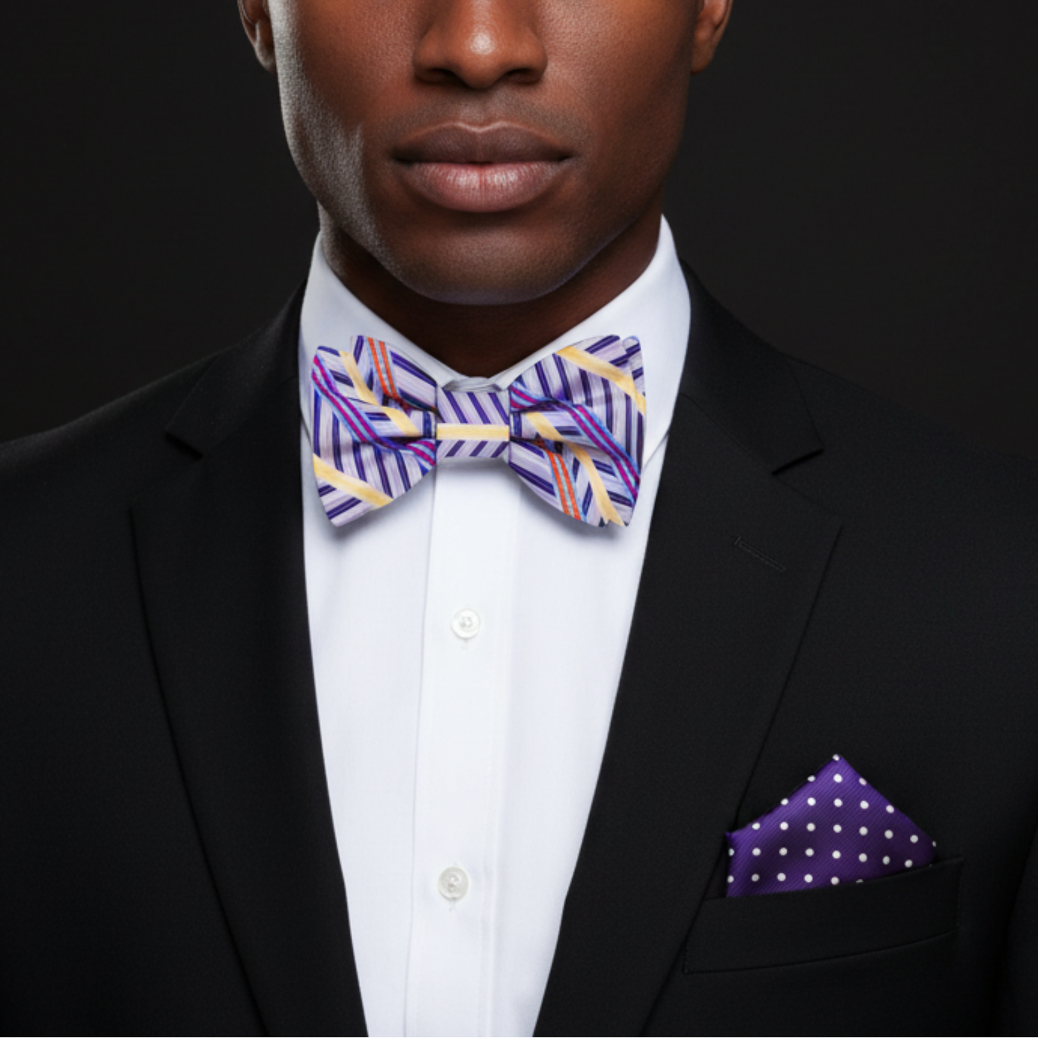 Man wearing light purple with yellow stripe bow tie and accenting square