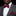 Man wearing a gray suit with a red patterned polka bow tie and pocket square on a black background