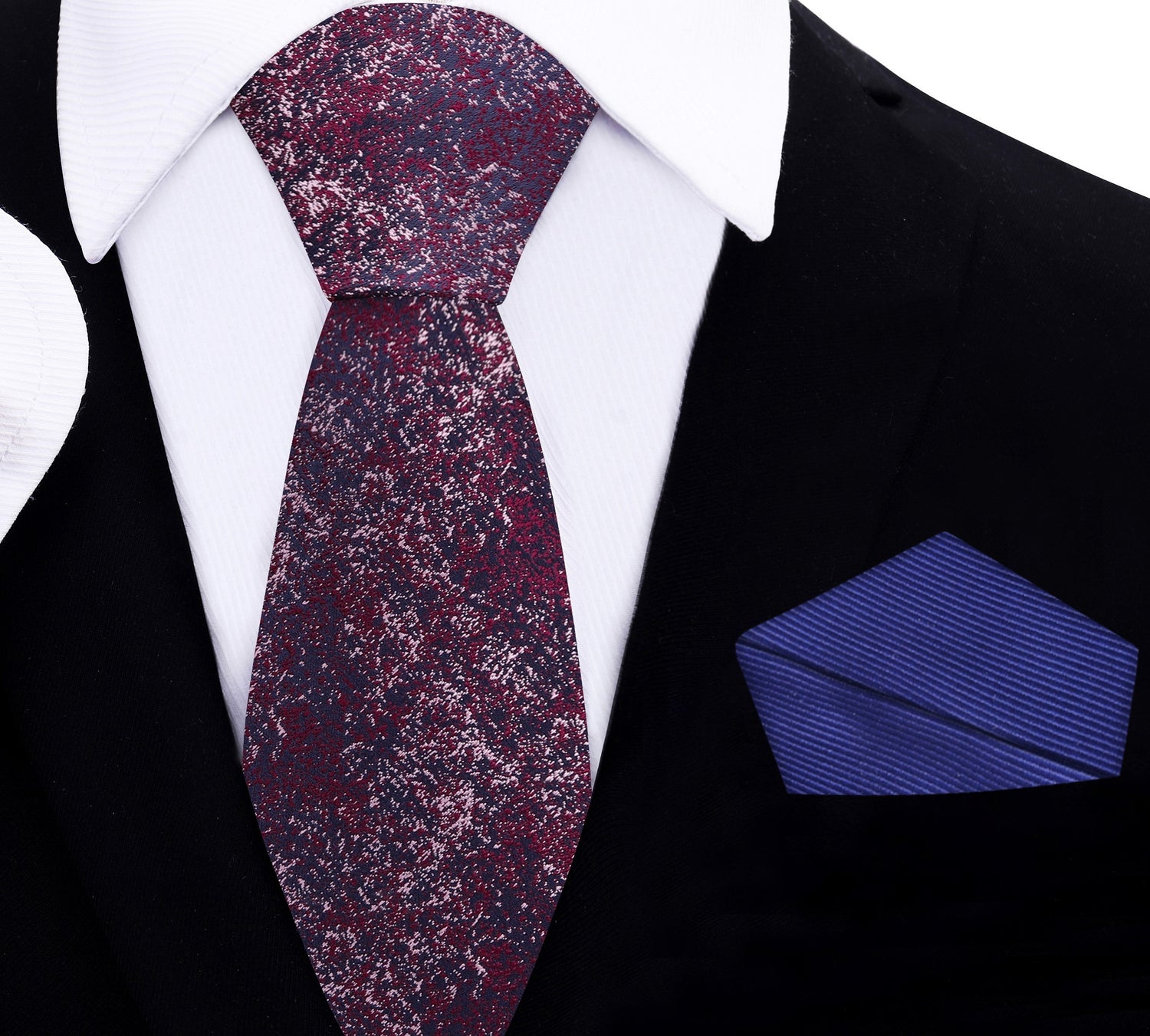 red and blue thin tie and blue pocket square on a black suit with white shirt