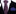 red and blue thin tie and blue pocket square on a black suit with white shirt