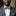 Man wearing a gray suit with a red, pink floral bow tie and pocket square.