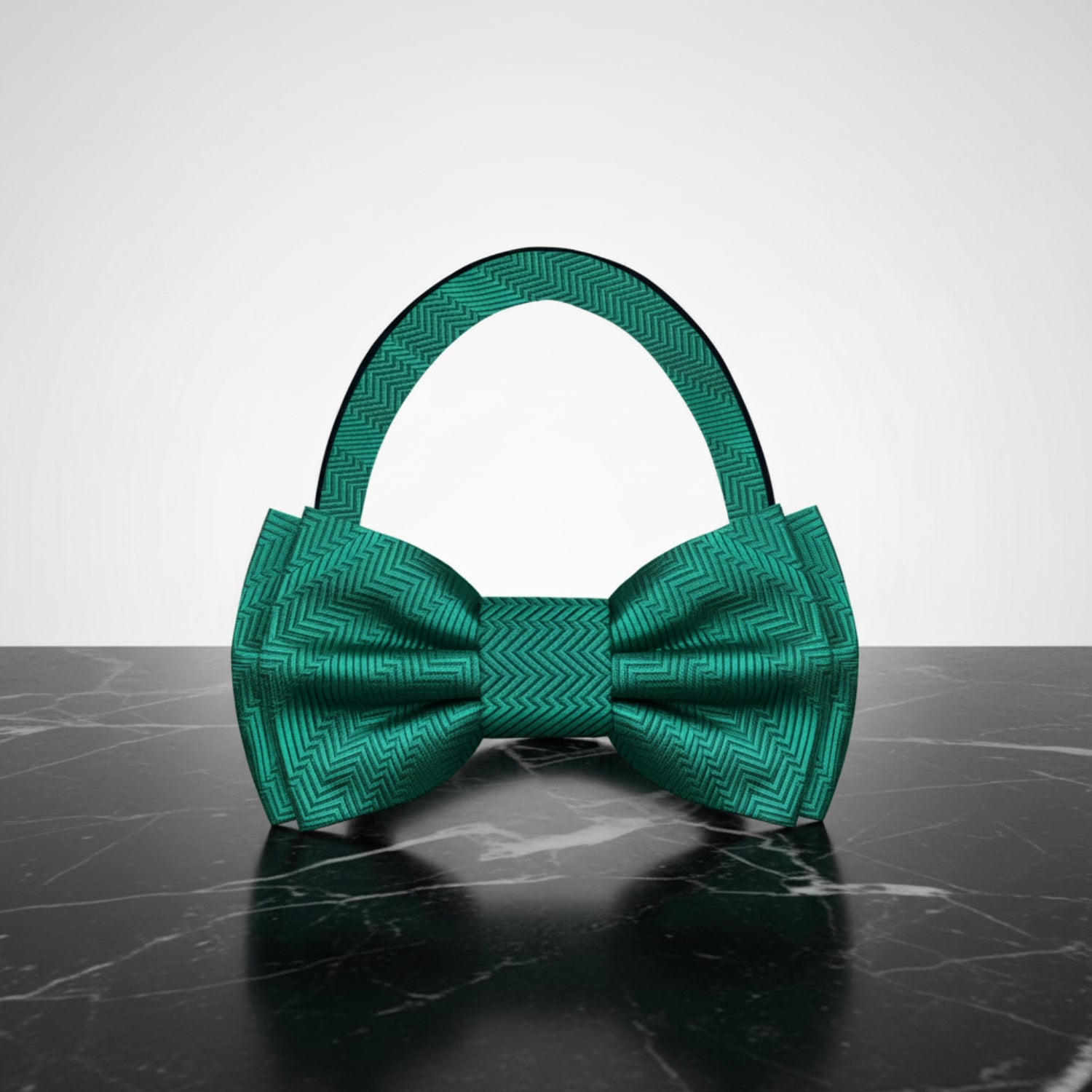 Green bow tie with a geometric pattern on a white background