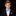 Young boy in a suit with a blue bow tie against a black background