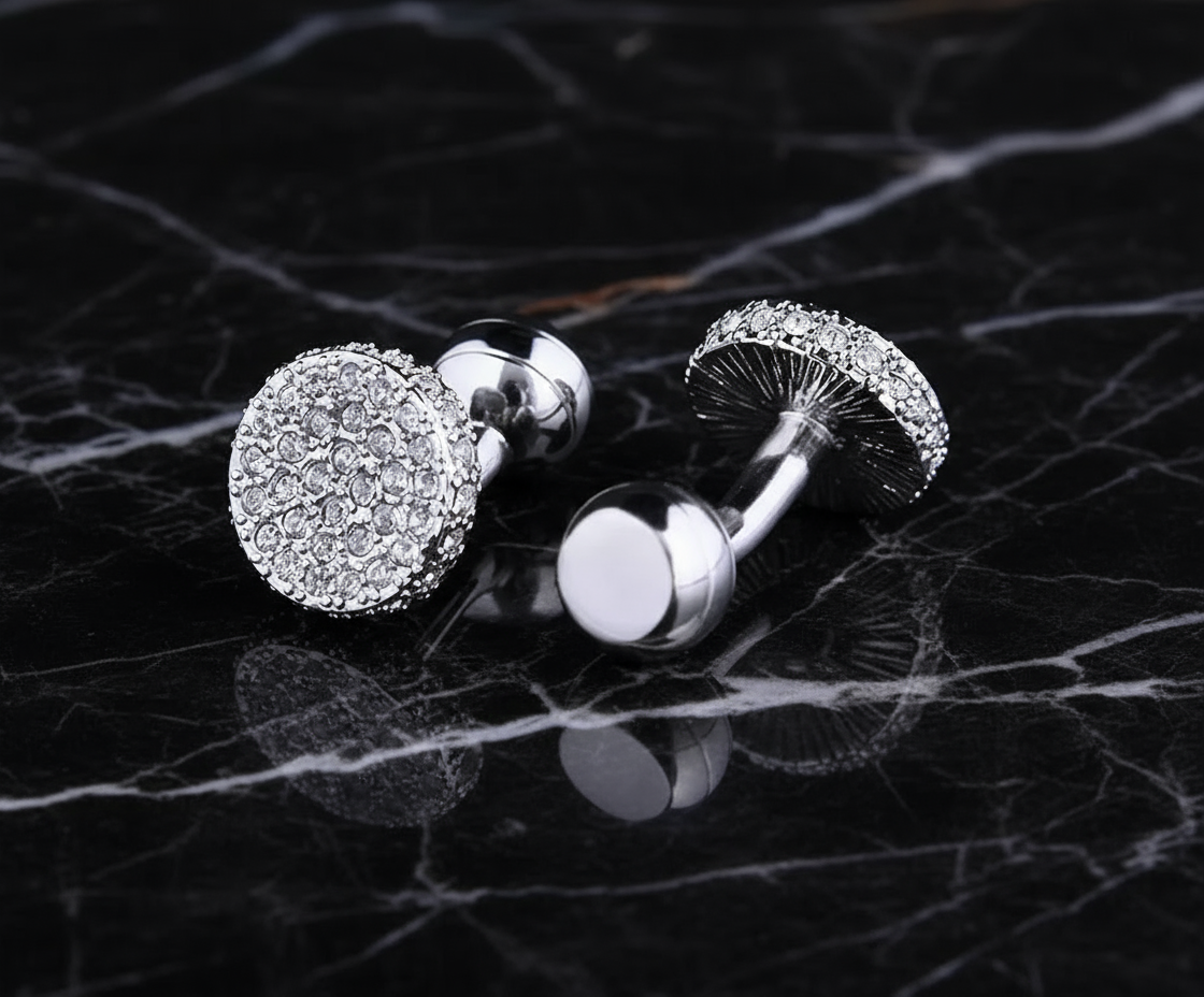 A circular shape silver and clear stone colored cuff-links||Silver