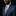 Man wearing a navy suit with a lion brooch on a black background